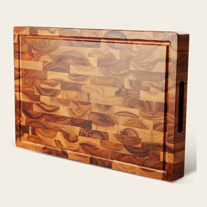 Acacia end-grain cutting board with a juice groove and a recessed side grip